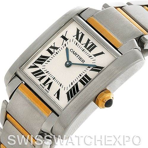 The image shows a close-up of a Cartier Tank Française watch, focusing on the face, crown, and part of the metal bracelet.