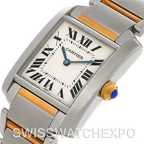 The image shows a close-up, angled view of the Cartier Tank Francaise Women's Steel and Gold (two tone) Silver Dial Women's Steel and Gold (two tone) Silver Dial watch face, bracelet, and crown with a blue cabochon.
