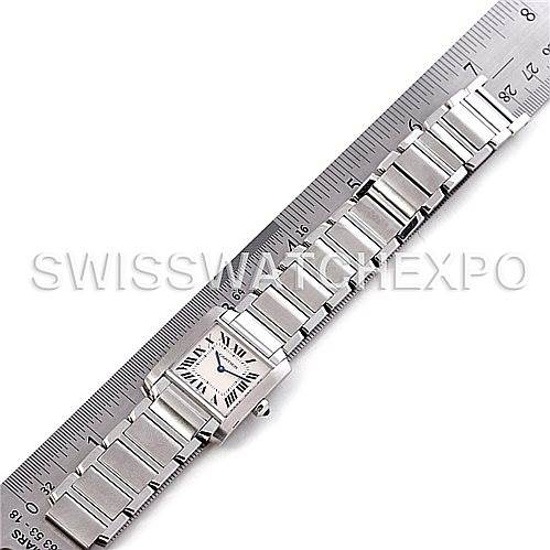 The image shows a Cartier Tank Française watch fully extended beside a ruler for scale, displaying the face and bracelet.