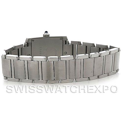 The image shows the back view of a Cartier Tank Française watch, highlighting its stainless steel bracelet and clasp.