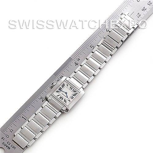 The Cartier Tank Française watch is shown fully extended, placed next to a ruler for size reference.