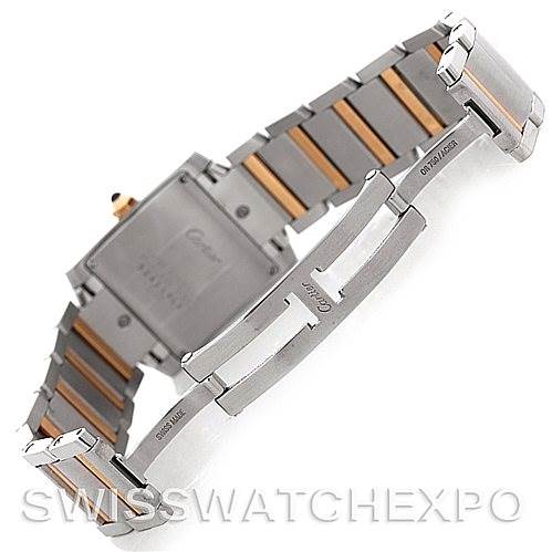 The image shows the clasp and strap of a Cartier Tank Française watch, highlighting the two-tone metal links and engraving details.