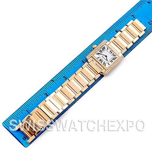 The Cartier Tank Francaise WE1017R8 Women's Yellow Gold Silver Dial WE1017R8 Women's Yellow Gold Silver Dial watch is shown from a top view with its bracelet stretched out on a ruler.