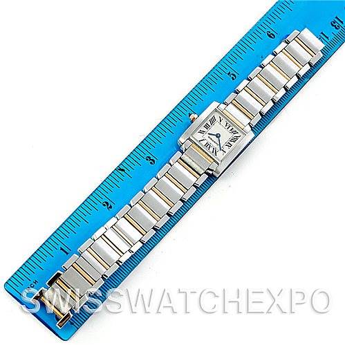 The Cartier Tank Française watch is shown flat, displaying the entire band and face, placed along a blue ruler for scale.