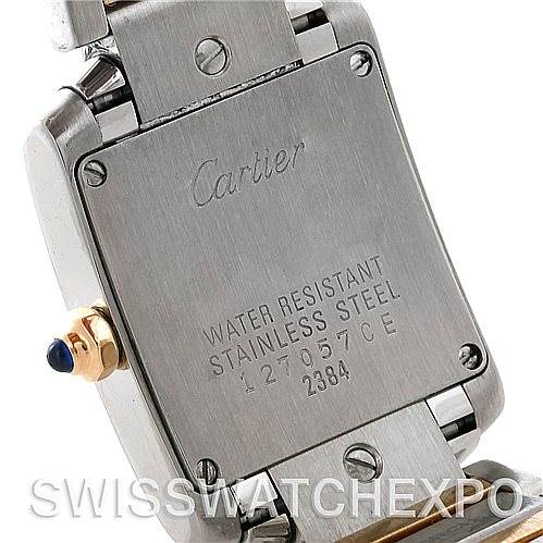 The image shows the back case of a Cartier Tank Française watch, highlighting the engravings and stainless steel construction.