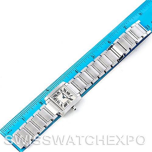 This image shows a Cartier Tank Francaise W51011Q3 Women
s Stainless Steel Silver Dial W51011Q3 Women
s Stainless Steel Silver Dial watch fully extended along a ruler for scale, displaying its bracelet and face.