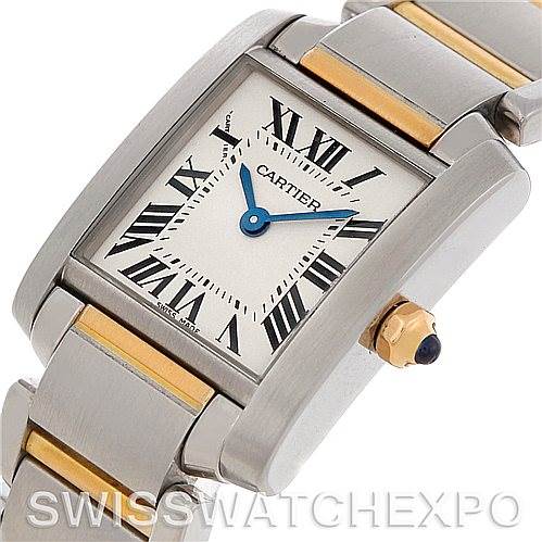 The image shows a close-up view of the Cartier Tank Française watch face and part of the bracelet, highlighting the Roman numerals and crown.