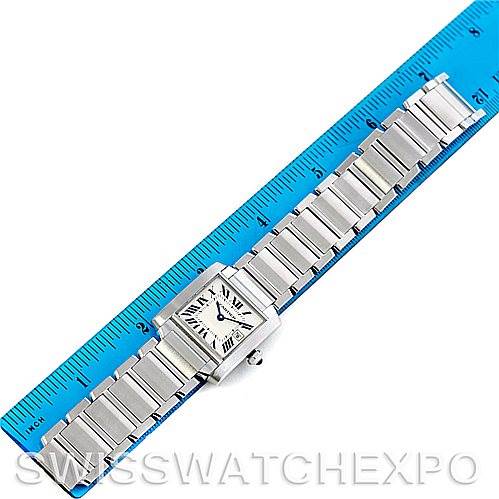 The image shows an overhead view of a Cartier Tank Française watch placed next to a ruler, highlighting its entire bracelet and watch face.