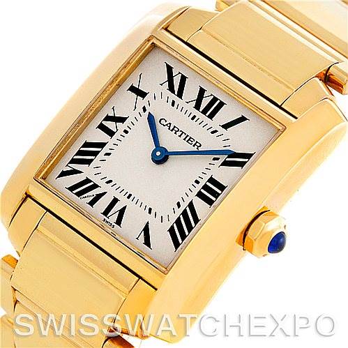 This Cartier Tank Francaise W50003N2 Women's Yellow Gold Silver Dial W50003N2 Women's Yellow Gold Silver Dial watch is shown from an angled front view, highlighting its rectangular gold case, bracelet, and crown with a blue sapphire cabochon.
