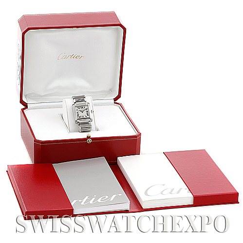 The Cartier Tank Française watch is shown from the front inside its opened red box, with accompanying manuals nearby.