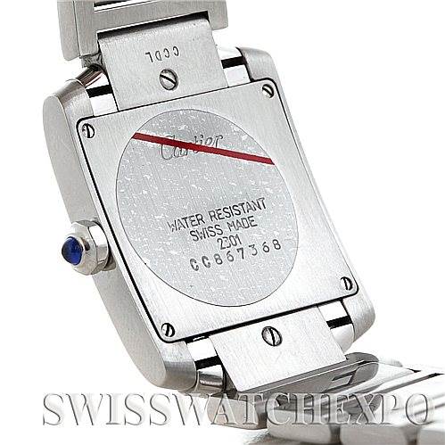 The image shows the back case and part of the bracelet of a Cartier Tank Française watch, highlighting its water resistance marking, serial number, and crown.