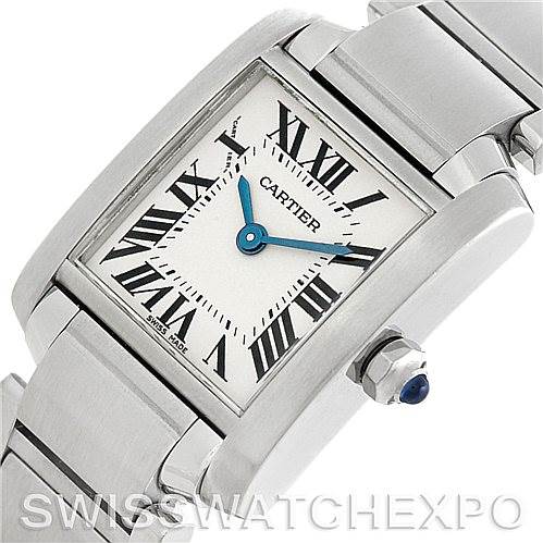 The image shows a close-up angle of the Cartier Tank Française watch, highlighting its face, Roman numerals, blue hands, and crown.
