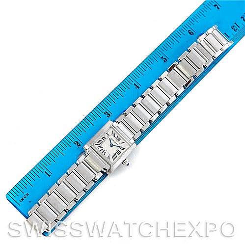 The image shows an overhead view of a Cartier Tank Francaise W51008Q3 Women's Stainless Steel White Dial W51008Q3 Women's Stainless Steel White Dial watch, lying next to a blue ruler for size reference.