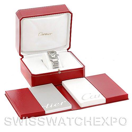 The image shows a Cartier Tank Française watch in its open red display box, accompanied by manuals placed in front.