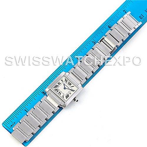 The image shows a detailed top-down view of a Cartier Tank Française watch laying alongside a ruler.