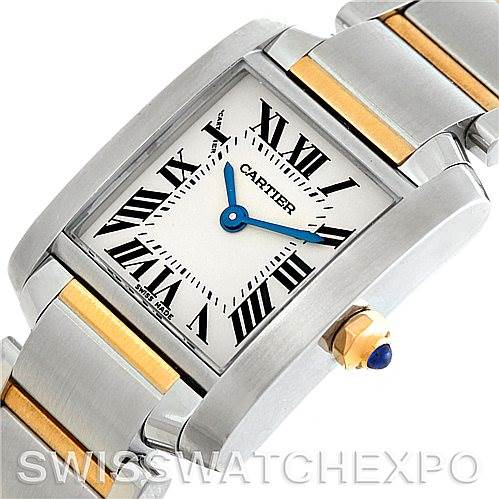 The image shows a top view of a Cartier Tank Française watch, highlighting its rectangular face, Roman numerals, blue hands, and metal bracelet.