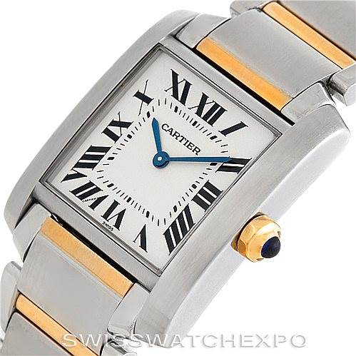 The image shows a close-up of the Cartier Tank Française watch face and part of its two-tone bracelet, featuring Roman numerals and blue hands.