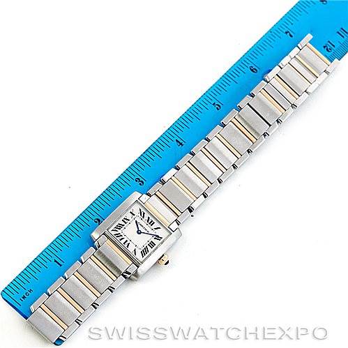 The image shows a Cartier Tank Francaise Women's Steel and Gold (two tone) Silver Dial Women's Steel and Gold (two tone) Silver Dial watch laid flat alongside a blue ruler for measurement.