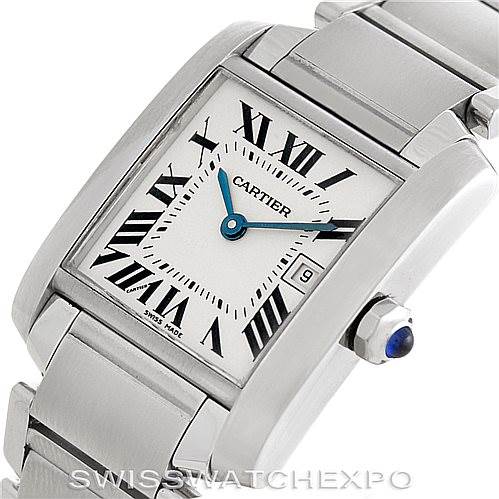 The image shows a close-up angled view of a Cartier Tank Française watch, highlighting its face, bracelet, and crown with a blue cabochon.