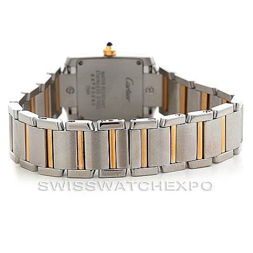 The image shows the back of the Cartier Tank Française watch with its stainless steel and gold bracelet.
