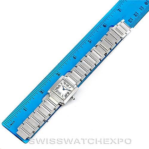 This image shows a top view of a Cartier Tank Française watch alongside a blue ruler for size reference.