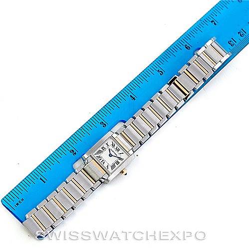 The image shows a Cartier Tank Francaise W51007Q4 Women's Steel and Gold (two tone) Silver Dial W51007Q4 Women's Steel and Gold (two tone) Silver Dial watch placed alongside a blue ruler, showcasing its face and bracelet band.