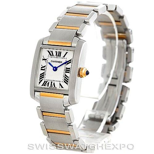 This image shows a Cartier Tank Francaise W51007Q4 Women's Steel and Gold (two tone) Silver Dial W51007Q4 Women's Steel and Gold (two tone) Silver Dial watch angled to display its face, two-tone bracelet, and crown with a blue cabochon.