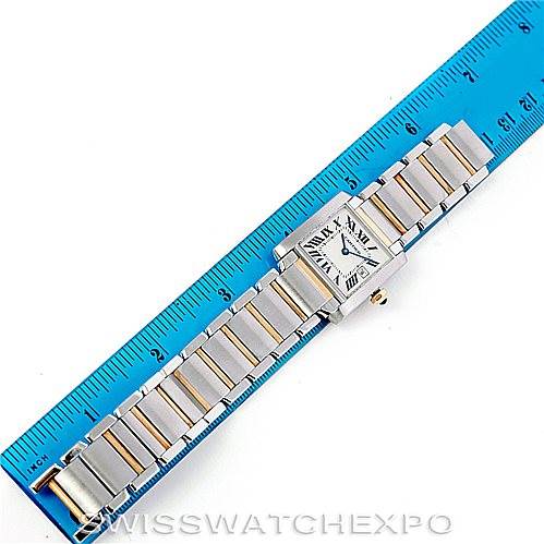 The image shows an overhead view of a Cartier Tank Française watch placed next to a ruler.