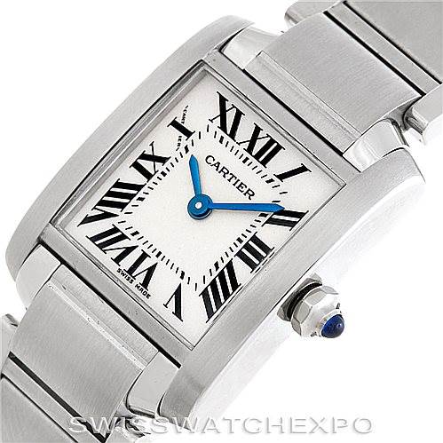 The image shows a close-up angle of the Tank Francaise by Cartier, featuring the dial, Roman numerals, and part of the bracelet.