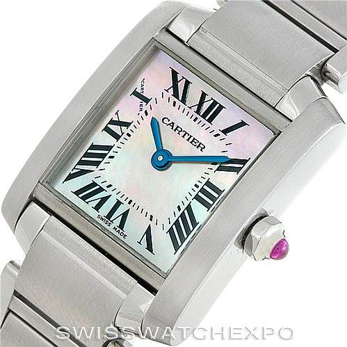 The image shows a close-up of a Cartier Tank Française watch, highlighting the face, Roman numerals, hands, and side crown with a gem.