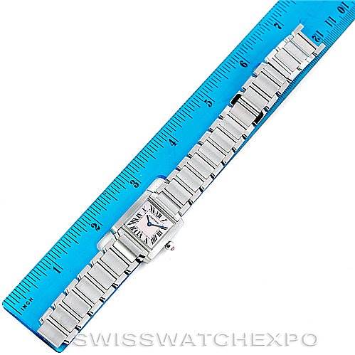 The image shows a Cartier Tank Française watch from an overhead angle, aligned with a ruler for scale.