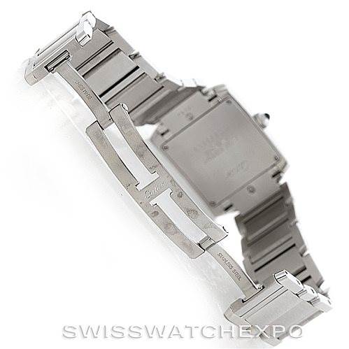 The image shows the underside of the Cartier Tank Française watch, highlighting its stainless steel bracelet and clasp.