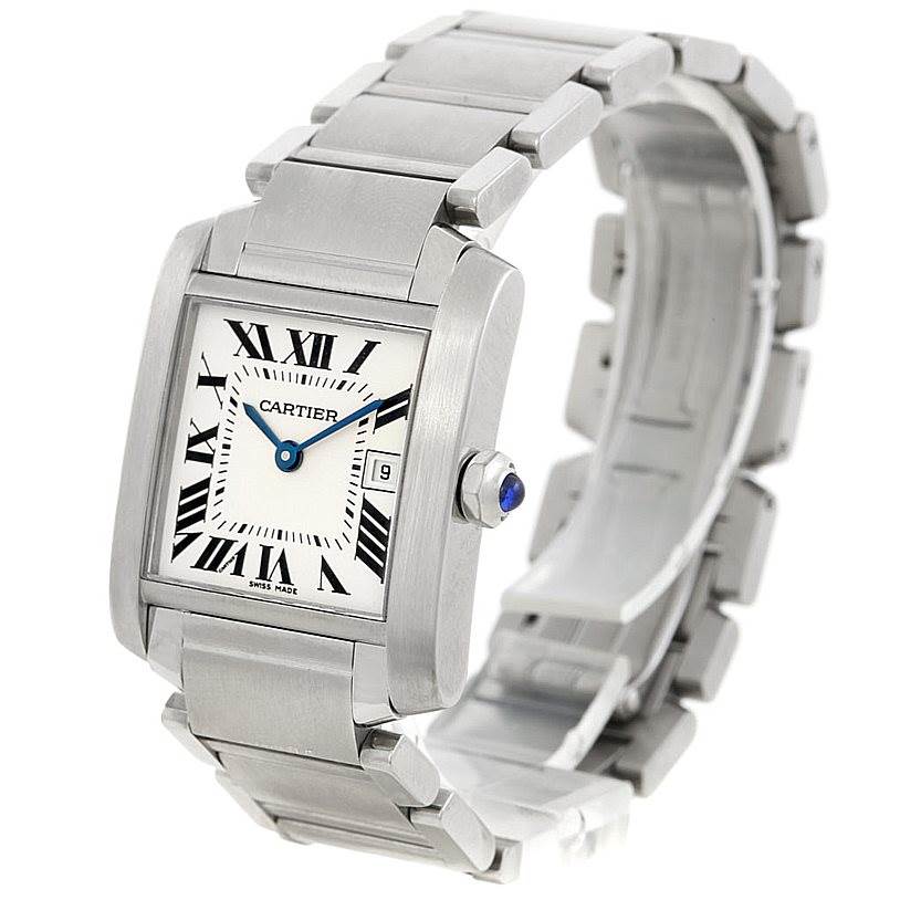 The image shows a Cartier Tank Française watch with a silver bracelet, Roman numeral dial, and blue cabochon crown.