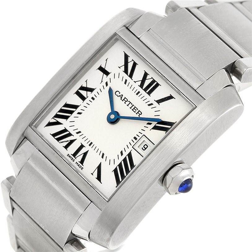 The image shows a Cartier Tank Française watch at an angled close-up, highlighting the dial, crown, and part of the bracelet.