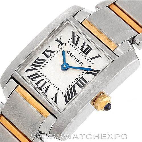 This image is a close-up of the face and partial band of a Cartier Tank Française watch, showing the dial, Roman numerals, and blue hands.