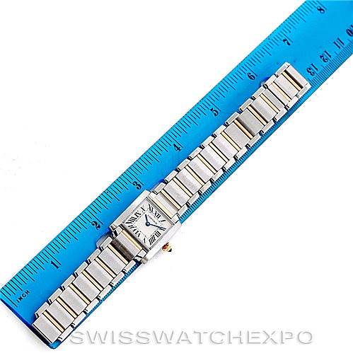The Cartier Tank Française watch is laid flat with the face and bracelet visible, alongside a ruler for size reference.