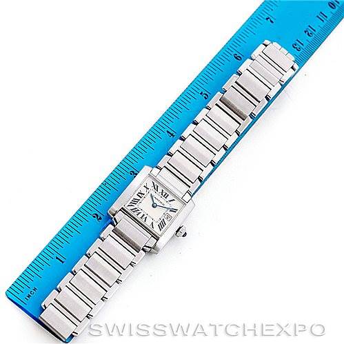 This image shows a Cartier Tank Francaise W51011Q3 Women's Stainless Steel Silver Dial W51011Q3 Women's Stainless Steel Silver Dial watch laid next to a ruler, displaying the watch face and full metal bracelet.