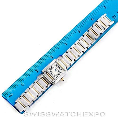 The image shows a Cartier Tank Francaise W51007Q4 Women's Steel and Gold (two tone) Silver Dial W51007Q4 Women's Steel and Gold (two tone) Silver Dial watch placed next to a blue ruler, displaying the watch's face and metal bracelet.