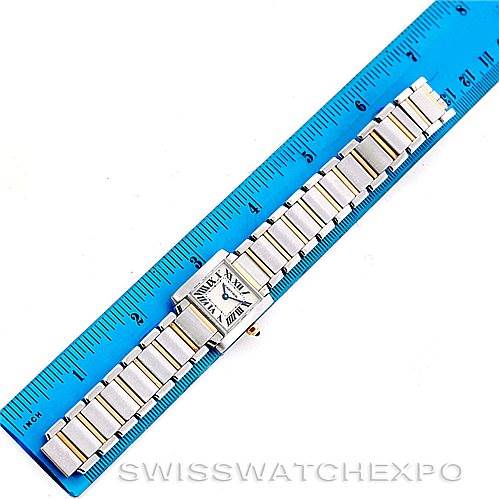 The Cartier Tank Francaise W51007Q4 Women's Steel and Gold (two tone) Silver Dial W51007Q4 Women's Steel and Gold (two tone) Silver Dial watch is shown from a top-down angle, displaying its square face and metal bracelet next to a ruler for scale.