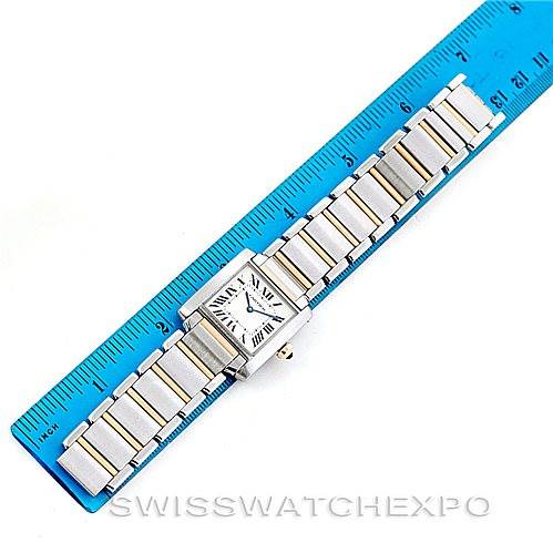 The image shows a Cartier Tank Francaise Women's Steel and Gold (two tone) Silver Dial Women's Steel and Gold (two tone) Silver Dial watch laid flat against a ruler, displaying its rectangular face and metal bracelet.