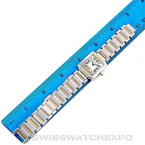 The Cartier Tank Francaise W51007Q4 Women's Steel and Gold (two tone) Silver Dial W51007Q4 Women's Steel and Gold (two tone) Silver Dial watch is shown lying flat next to a blue ruler, displaying its bracelet and watch face.