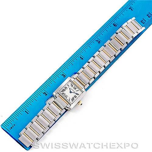 This image shows an aerial view of a Cartier Tank Française watch, placed against a ruler for size reference.