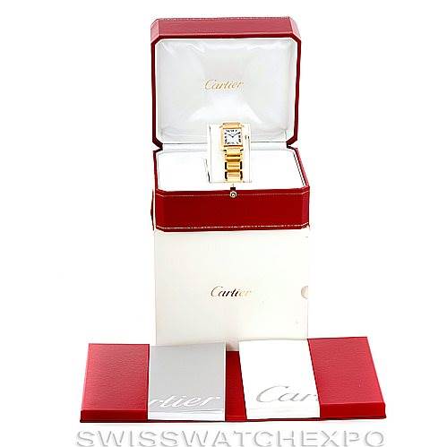 This image shows the Cartier Tank Française watch in its open red box, accompanied by its packaging and booklets.