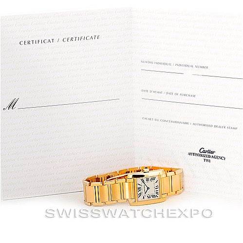 The image shows a Cartier Tank Francaise W50003N2 Women's Yellow Gold Silver Dial W50003N2 Women's Yellow Gold Silver Dial watch and its certificate, photographed from an angled top-view.