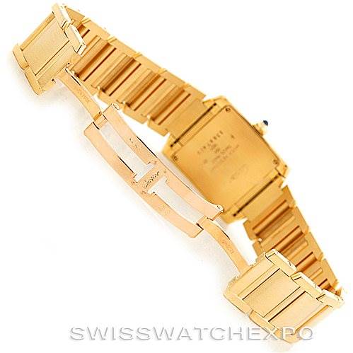The image shows the back and clasp of a Cartier Tank Française watch, showcasing its gold bracelet and deployment clasp.