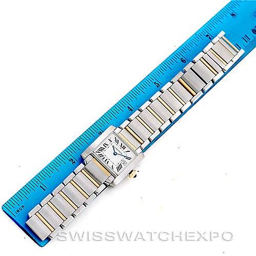 The Cartier Tank Francaise W51012Q4 Women's Steel and Gold (two tone) Silver Dial W51012Q4 Women's Steel and Gold (two tone) Silver Dial watch is shown from a top-down angle, displaying its face and bracelet next to a ruler for size reference.