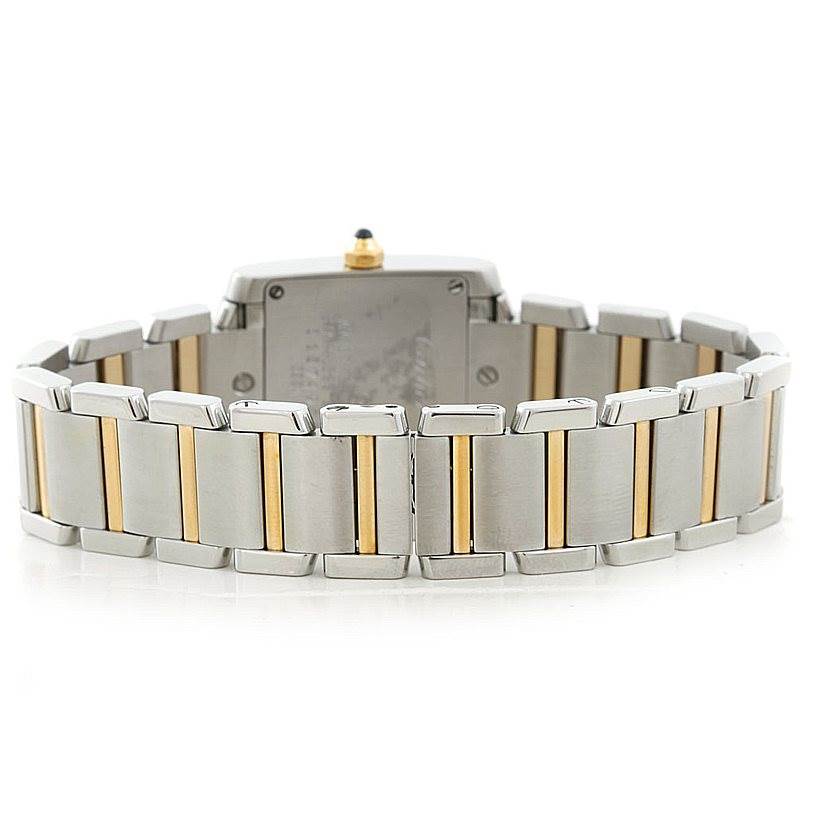 The image shows the back view of a Cartier Tank Française watch, highlighting its two-tone metal bracelet.