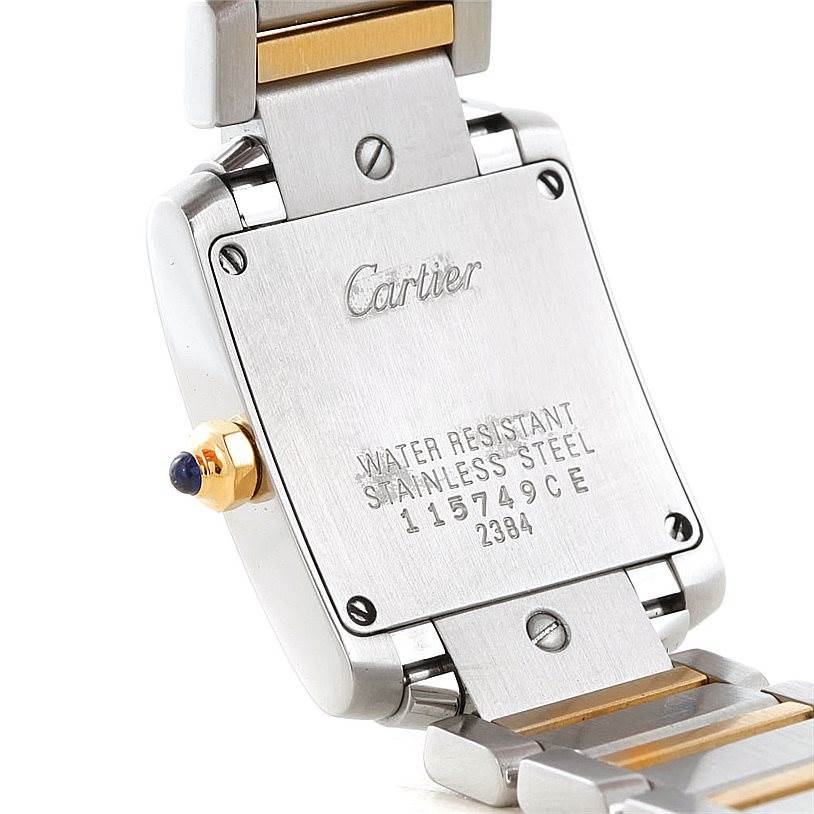 The image shows the back case and part of the bracelet of a Cartier Tank Francaise W51007Q4 Women's Steel and Gold (two tone) Silver Dial W51007Q4 Women's Steel and Gold (two tone) Silver Dial watch, focusing on the inscription details.