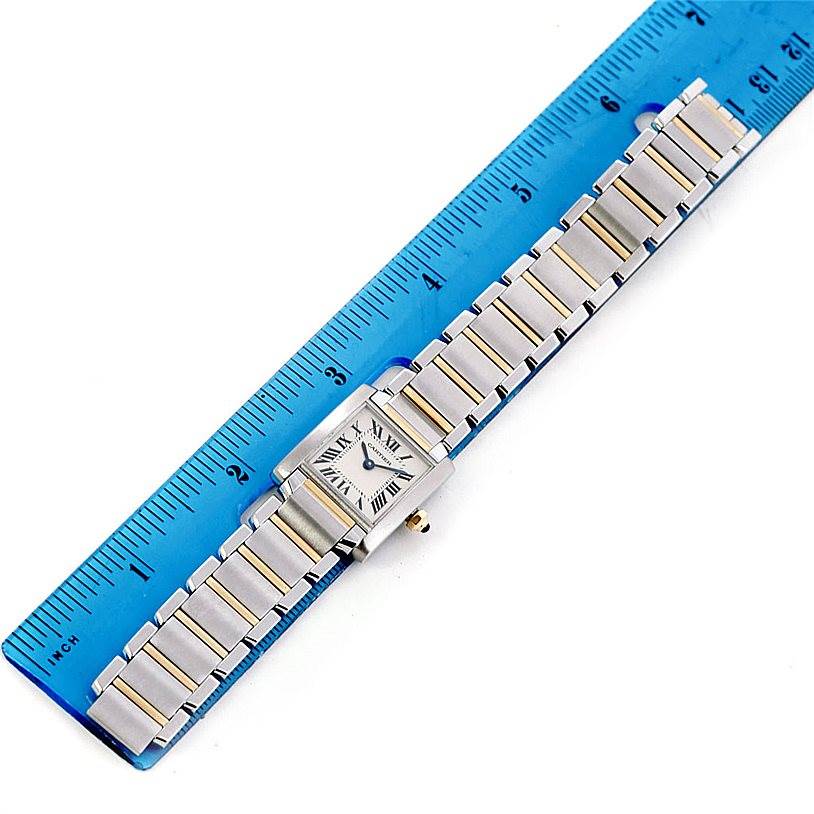The image shows a Cartier Tank Francaise W51007Q4 Women's Steel and Gold (two tone) Silver Dial W51007Q4 Women's Steel and Gold (two tone) Silver Dial watch laid flat next to a ruler, highlighting its full length and bracelet.