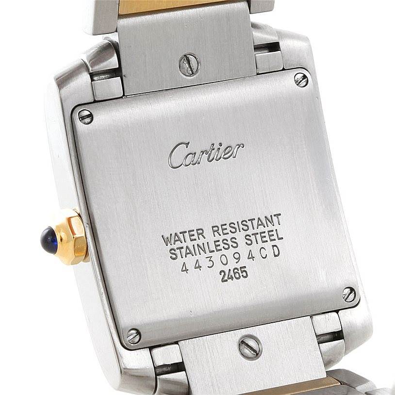 The image shows the back case of a Cartier Tank Francaise W51012Q4 Women's Steel and Gold (two tone) Silver Dial W51012Q4 Women's Steel and Gold (two tone) Silver Dial watch, highlighting the engravings and part of the bracelet.